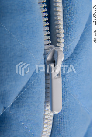 Zipper cashmere sweater macro. Fashionable blue jacket with a zipper for the cold season. Casual stylish clothes. Side plan. 125906376