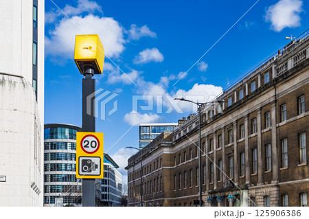 Speed Camera Mounted on Pole Enforcing Traffic Regulations on City Street 125906386