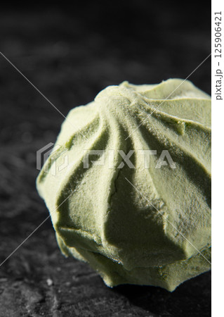 Natural marshmallow, green, apple on a black background close-up. Natural marshmallow, green, apple on a black background close-up. 125906421