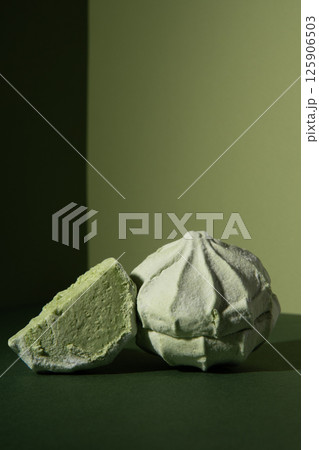 Green sweetness marshmallows on a green background for a banner. Geometry. Studio photo. Green sweetness marshmallows on a green background for a banner. Geometry. Studio photo. 125906503