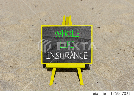 Whole life insurance symbol. Concept words Whole life insurance on beautiful black yellow blackboard. Beautiful sand beach background. Business whole life insurance concept. Copy space. 125907021
