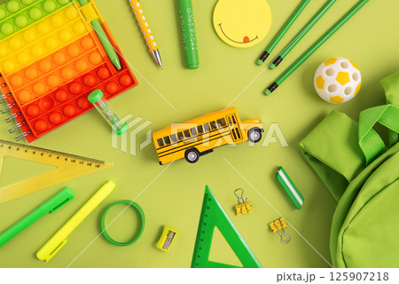Back to school concept. Border made of school supplies on green background. Top view. Copy space Back to school concept. Border made of school supplies on green background. Top view. Copy space 125907218