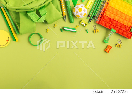 Back to school concept. Border made of school supplies on green background. Top view. Copy space Back to school concept. Border made of school supplies on green background. Top view. Copy space 125907222