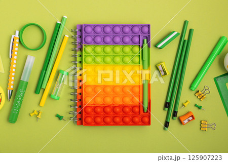 Back to school concept. Border made of school supplies on green background. Top view. Copy space Back to school concept. Border made of school supplies on green background. Top view. Copy space 125907223