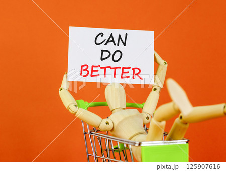Can do better symbol. Concept words Can do better on beautiful white card. Beautiful orange background. Businessman model in shop cart. Business and can do better concept. Copy space. 125907616