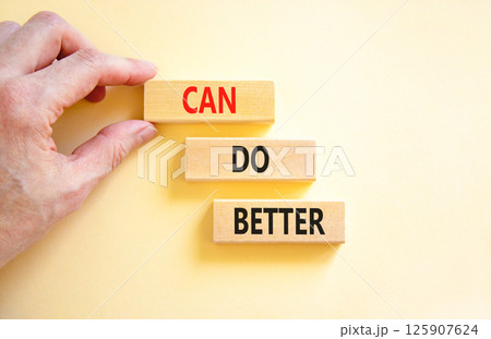 Can do better symbol. Concept words Can do better on beautiful wooden block. Businessman's hand. Beautiful white background. Business and can do better concept. Copy space. 125907624