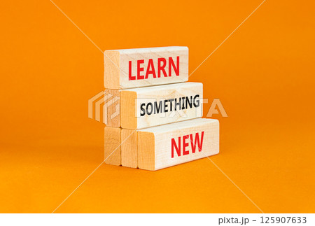 Learn something new symbol. Concept words Learn something new on beautiful block. Beautiful orange table orange background. Business motivational lifestyle learn something new concept Copy space 125907633