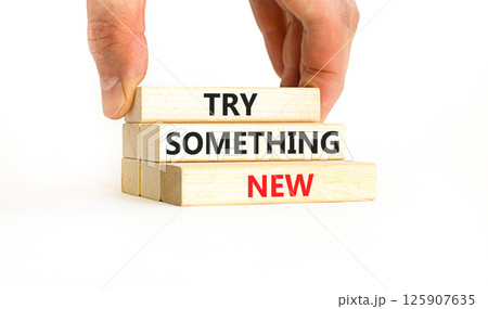 Try something new symbol. Concept words Try something new on beautiful block. Businessman's hand. Beautiful white background. Business motivational lifestyle try something new concept. Copy space. 125907635