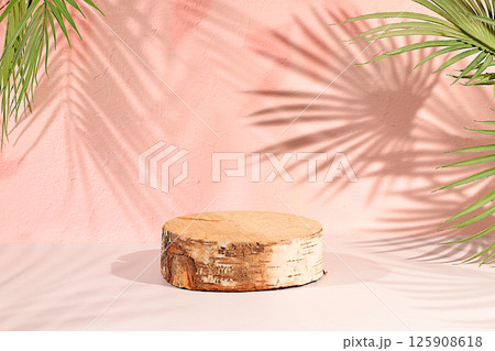 Premium empty wooden birch podium with shadows on sunny elegant background,Minimal abstract backdrop for cosmetic products presentation,beauty aesthetics,template for design,summer party concept. 125908618