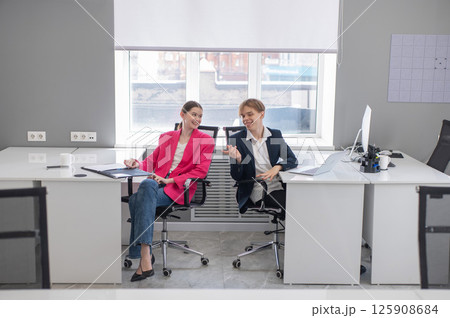 Colleagues communicate while at work in the office. Colleagues communicate while at work in the office. 125908684