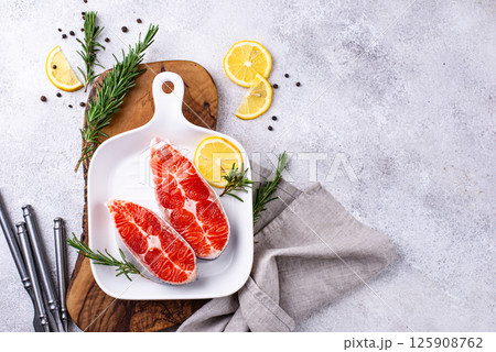 Raw uncooked salmon with rosemary Raw uncooked salmon with rosemary 125908762