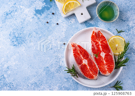 Raw uncooked salmon with rosemary Raw uncooked salmon with rosemary 125908763