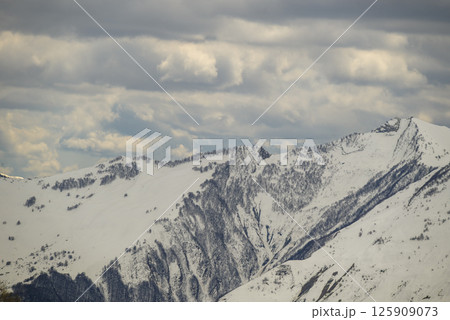 Snowcapped peaks of Caucasus mountains along the Georgian Military Road, major route from Georgia to Russia 125909073