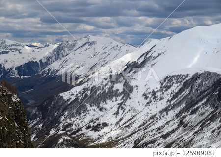 Snowcapped peaks of Caucasus mountains along the Georgian Military Road, major route from Georgia to Russia 125909081