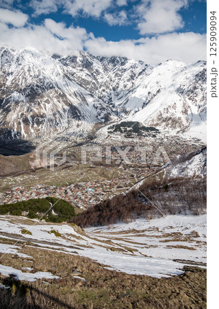 Town of Stepantsminda in Caucasus mountains along the Georgian Military Road, major route from Georgia to Russia 125909094