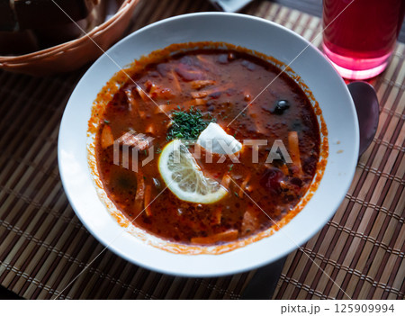 Traditional Russian meat soup Solyanka with sour cream and lemon Traditional Russian meat soup Solyanka with sour cream and lemon 125909994
