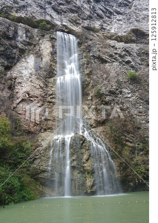 Majestic Waterfall Cascading Down a Rugged Cliff Face 125912813