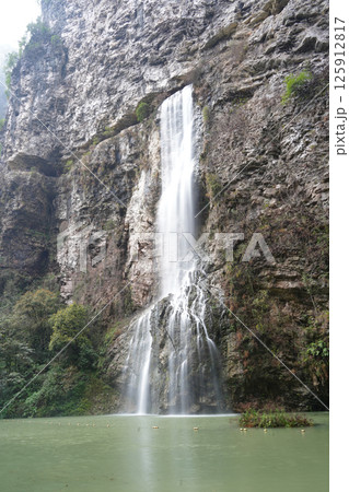 Majestic Waterfall Cascading Down a Rugged Cliff Face 125912817
