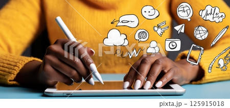 Close-up View of Hands Using a Tablet with Stylus on a Clean Desk Surface 125915018