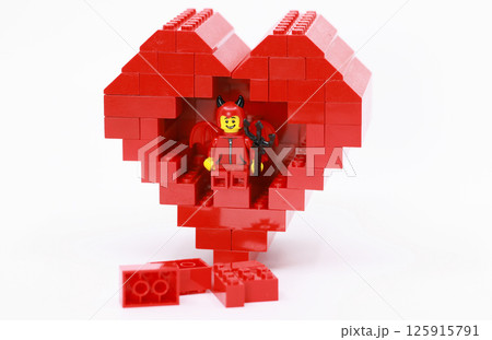 devil dressing child hide inside the heart shaped brick  125915791