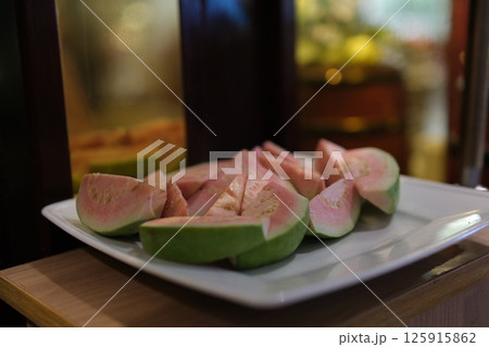 Isolated Guava, whole ripe guava fruit with sliced piece abd guava leaves. Isolated Guava, whole ripe guava fruit with sliced piece abd guava leaves. 125915862