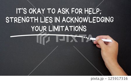 It is okay to ask for help, strength lies in acknowledging your limitations text written on black board. Inspirational and motivational concept. 125917316