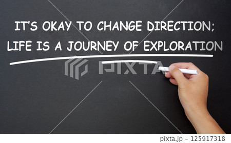 It is okay to change direction, life is a journey of exploration text written on black board. Inspirational and motivational concept. It is okay to change direction, life is a journey of exploration text written on black board. Inspirational and motivational concept. 125917318