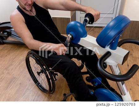 Disabled man training in the gym. Rehabilitation center Disabled man training in the gym. Rehabilitation center 125920703