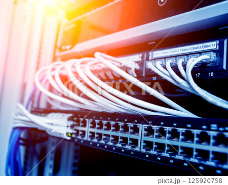Network switch and ethernet cables in red and white colors. Data Center Network switch and ethernet cables in red and white colors. Data Center 125920758