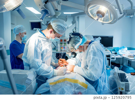 Spinal surgery. Group of surgeons in operating room with surgery equipment.  125920795
