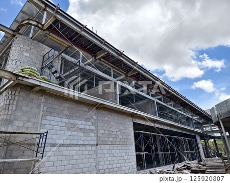 A large and impressive modern building is under construction. A large and impressive modern building is under construction. 125920807