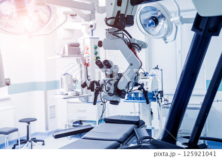 Modern microscope for operations in surgery room at the hospital. Modern microscope for operations in surgery room at the hospital. 125921041