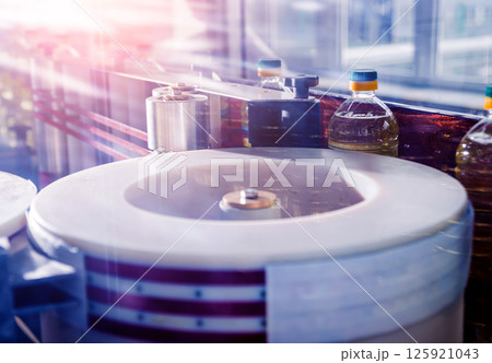Automatic labeling machine during operation. Factory for the production Automatic labeling machine during operation. Factory for the production 125921043