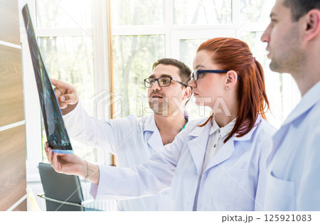 Doctors team having medical council in hospital. Discussing medical issues. Doctors team having medical council in hospital. Discussing medical issues. 125921083