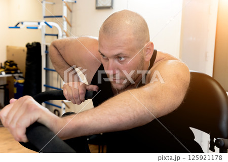 Disabled man training in the gym. Rehabilitation center Disabled man training in the gym. Rehabilitation center 125921178