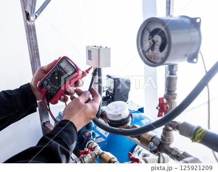 Technician checking water system nodes.Modern Industrial background 125921209