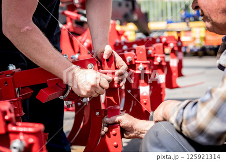 The mechanics repair combine harvester. Modern agricultural machinery The mechanics repair combine harvester. Modern agricultural machinery 125921314
