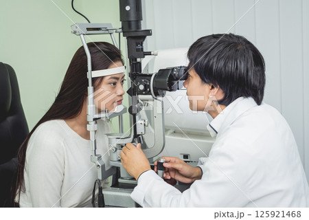 Consultation with an ophthalmologist. Young asian woman and doctor Consultation with an ophthalmologist. Young asian woman and doctor 125921468