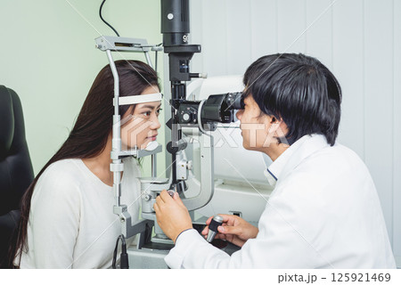 Consultation with an ophthalmologist. Young asian woman and doctor Consultation with an ophthalmologist. Young asian woman and doctor 125921469