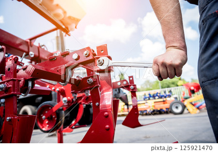 The mechanics repair combine harvester. Modern agricultural machinery The mechanics repair combine harvester. Modern agricultural machinery 125921470