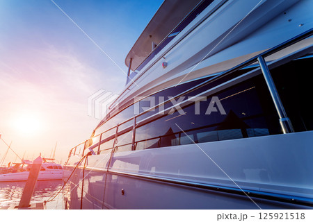 View of harbor with yachts details. Beautiful sunset sky in the marina bay. 125921518