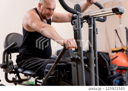 Disabled man training in the gym. Rehabilitation center 125921583