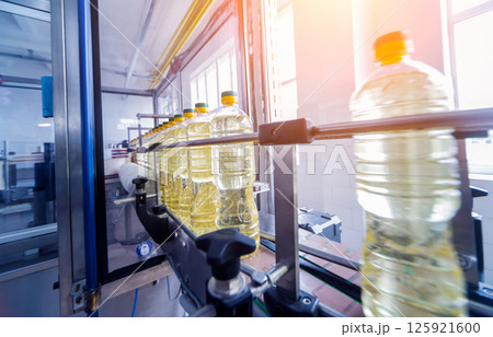 Bottling line of sunflower oil in bottles. Vegetable oil production plant 125921600