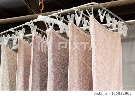 軒下に干された洗濯物のタオル 125921965