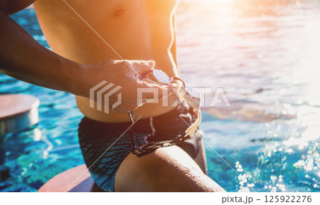 Young athletic man swimming in the swimming pool 125922276