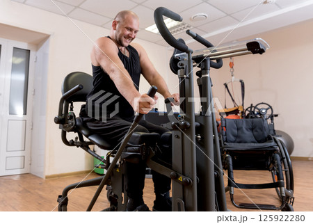 Disabled man training in the gym. Rehabilitation center 125922280