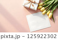 Elegant Gift Composition with Tulips and Blank Card on Pastel Background 125922302