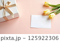 Elegant Gift Composition with Tulips and Blank Card on Pastel Background 125922306
