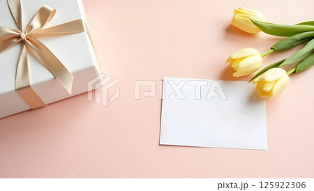Elegant Gift Composition with Tulips and Blank Card on Pastel Background 125922306