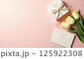 Elegant Gift Composition with Tulips and Blank Card on Pastel Background 125922308